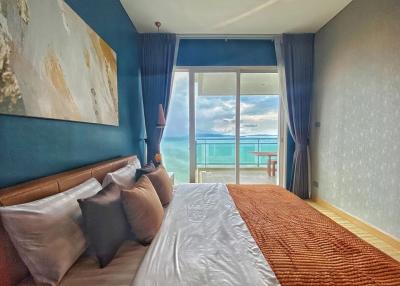 Cozy bedroom with a sea view and balcony access
