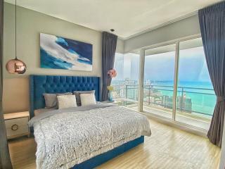 Modern bedroom with a large bed and ocean view