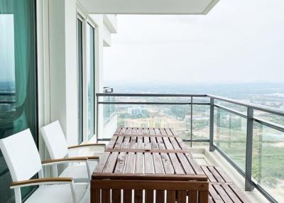 Spacious balcony with wooden furniture and panoramic view