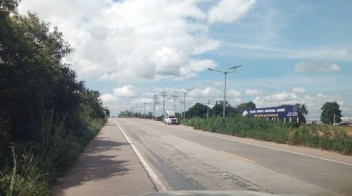 Roadway near a potential real estate development area under a clear sky