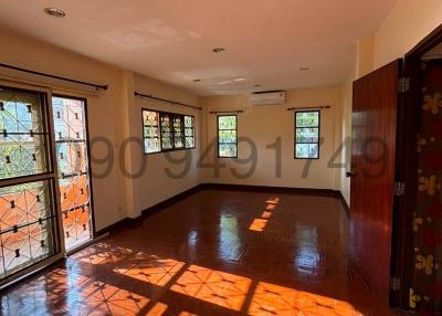 Spacious empty room with hardwood floors and natural light