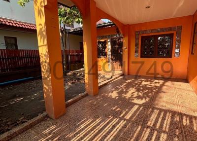 Sunlit patio with terracotta tiles and arched columns