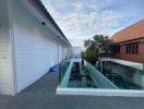 Spacious terrace with glass balustrade and a view of a residential area