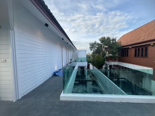 Spacious terrace with glass balustrade and a view of a residential area