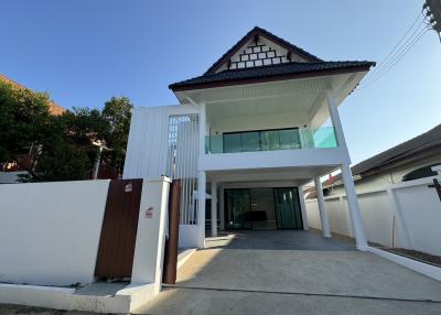 Modern two-story house with spacious driveway and balcony