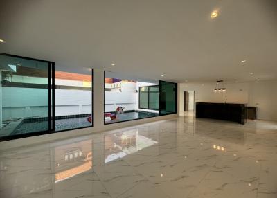 Spacious and illuminated living area with large windows and marble flooring