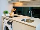 Modern kitchen area with built-in appliances and bright decor