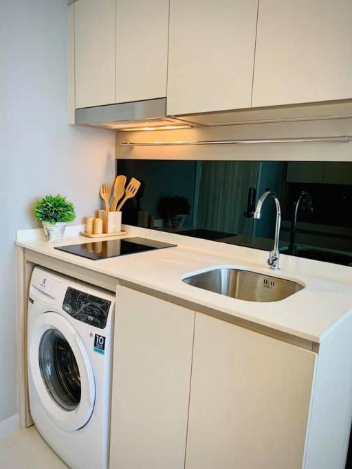 Modern kitchen area with built-in appliances and bright decor