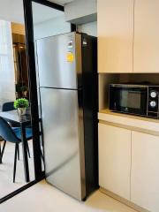 Modern kitchen with stainless steel refrigerator and microwave