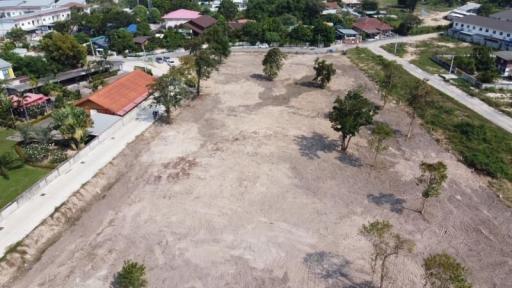 Aerial view of a spacious empty land plot in a suburban area