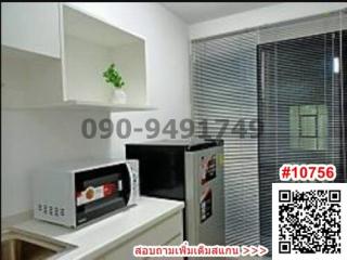 Modern kitchen with microwave and ample shelving