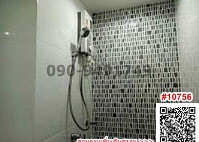 Modern bathroom with wall-mounted shower and decorative mosaic tiles