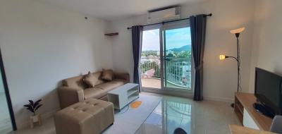 Modern living room with balcony access and scenic view