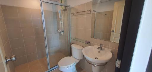 Modern bathroom with glass shower enclosure and beige tiles