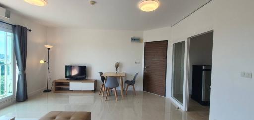 Spacious and well-lit living room with modern furniture and balcony access