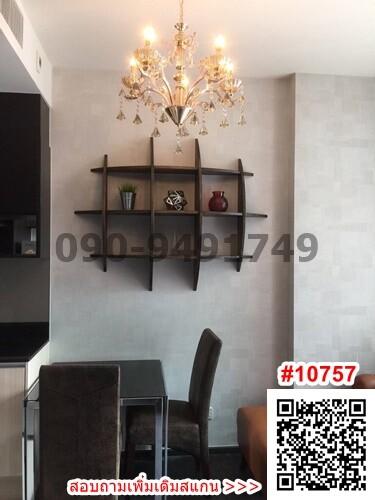 Contemporary dining space with elegant chandelier and wall-mounted shelves