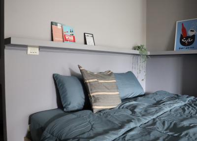 Cozy bedroom with decorative pillows and artwork