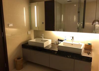 Modern bathroom with dual sinks and ample lighting