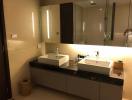 Modern bathroom with dual sinks and ample lighting