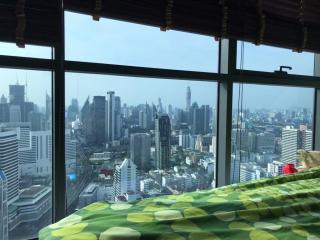 High-rise apartment living room with panoramic city view through floor-to-ceiling windows