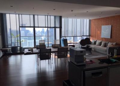 Spacious living room with large windows and city view