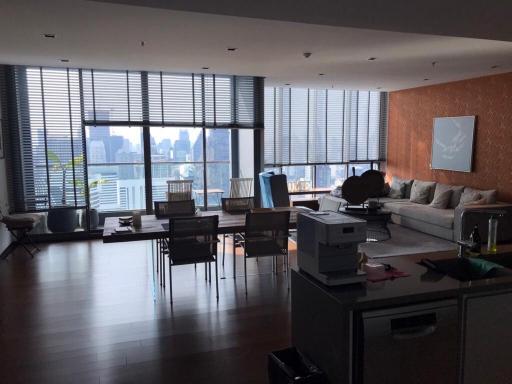 Spacious living room with large windows and city view