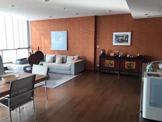 Spacious living room with modern furnishings and hardwood floors