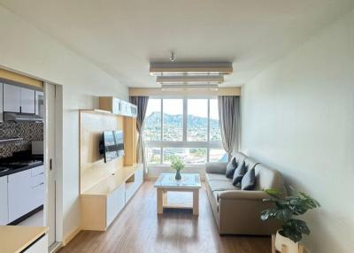 Spacious and well-lit living room with open kitchen setup