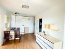 Bright and modern kitchen with wooden flooring and white cabinets