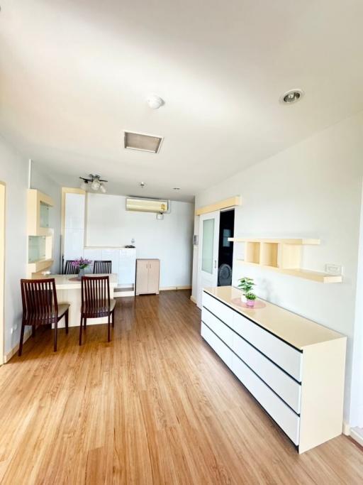 Bright and modern kitchen with wooden flooring and white cabinets