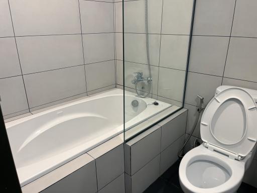 Modern bathroom with white tiles and glass shower partition