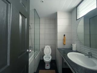 Modern bathroom with tiled walls and natural light