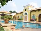 Luxurious villa with a large swimming pool and beautiful architecture under clear blue skies