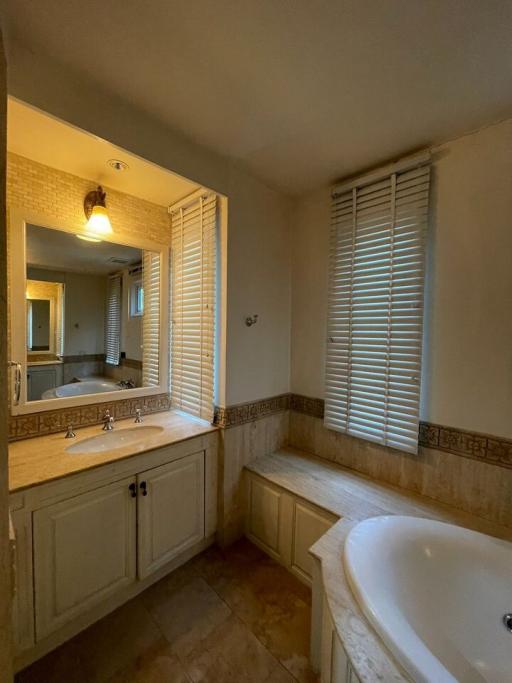 Spacious bathroom with natural light and double vanity