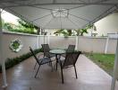 Covered patio with outdoor seating in a residential backyard