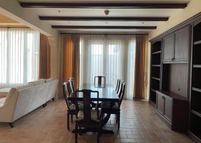 Spacious living room with dining area and built-in shelving