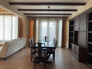 Spacious living room with dining area and built-in shelving