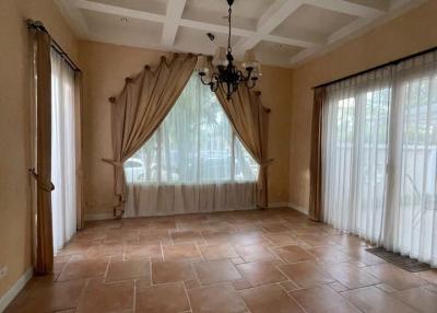 Spacious living room with large windows and coffered ceiling