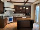 Spacious kitchen with dark wood cabinets and granite countertops