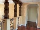 Elegant hallway with hardwood flooring and decorative balusters