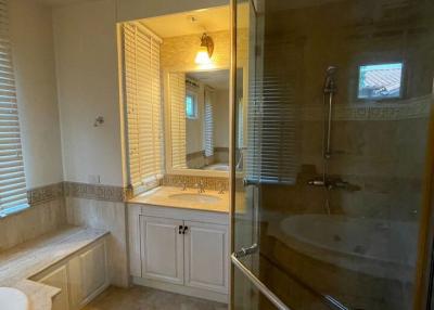 Spacious bathroom with glass shower and large mirror