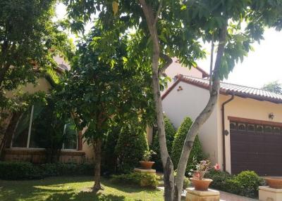 Charming two-story house with a well-manicured front yard and large garage door