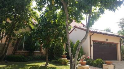 Charming two-story house with a well-manicured front yard and large garage door