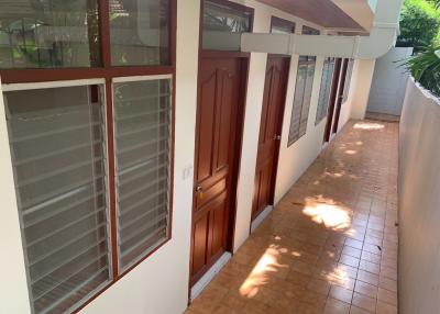 Brightly lit hallway with multiple doors and windows in a residential building