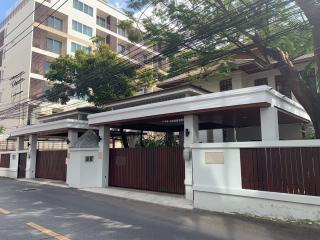 Modern apartment building behind a stylish wooden gated entrance