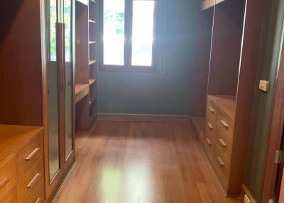 Spacious bedroom with wooden flooring and built-in wardrobe