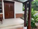 Elegant home entrance with wooden door and seating area