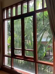 Large window with garden view in a well-lit room