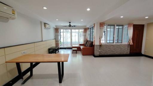 Spacious and well-lit living room with air conditioning and large windows