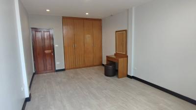 Spacious unfurnished room with wooden closet and tiled flooring
